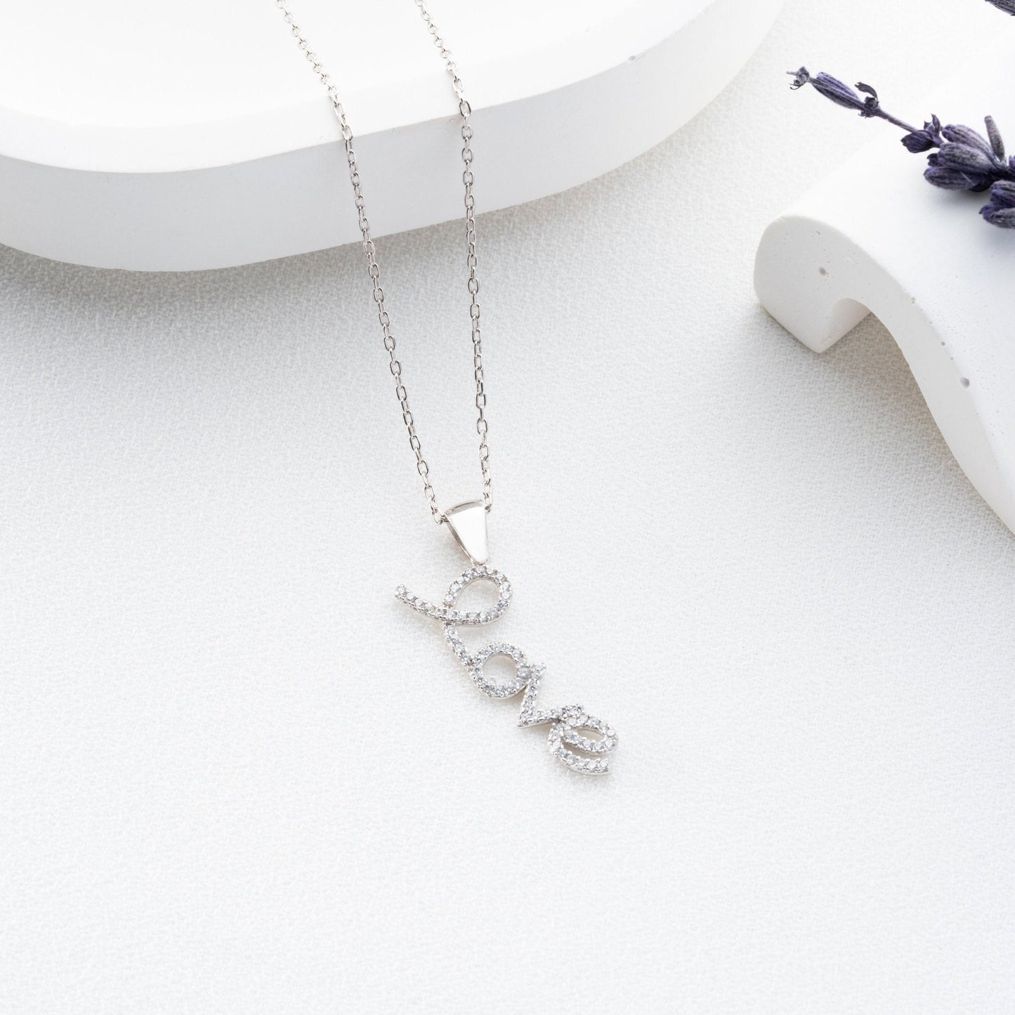 Handmade sterling silver; necklace with shimmering zircon stones delicately set along the word, reflecting elegance and romance