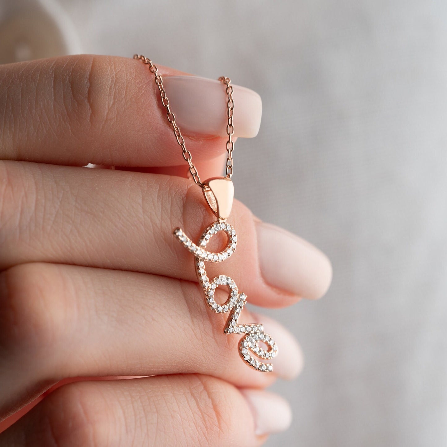 Handmade sterling silver; necklace with shimmering zircon stones delicately set along the word, reflecting elegance and romance