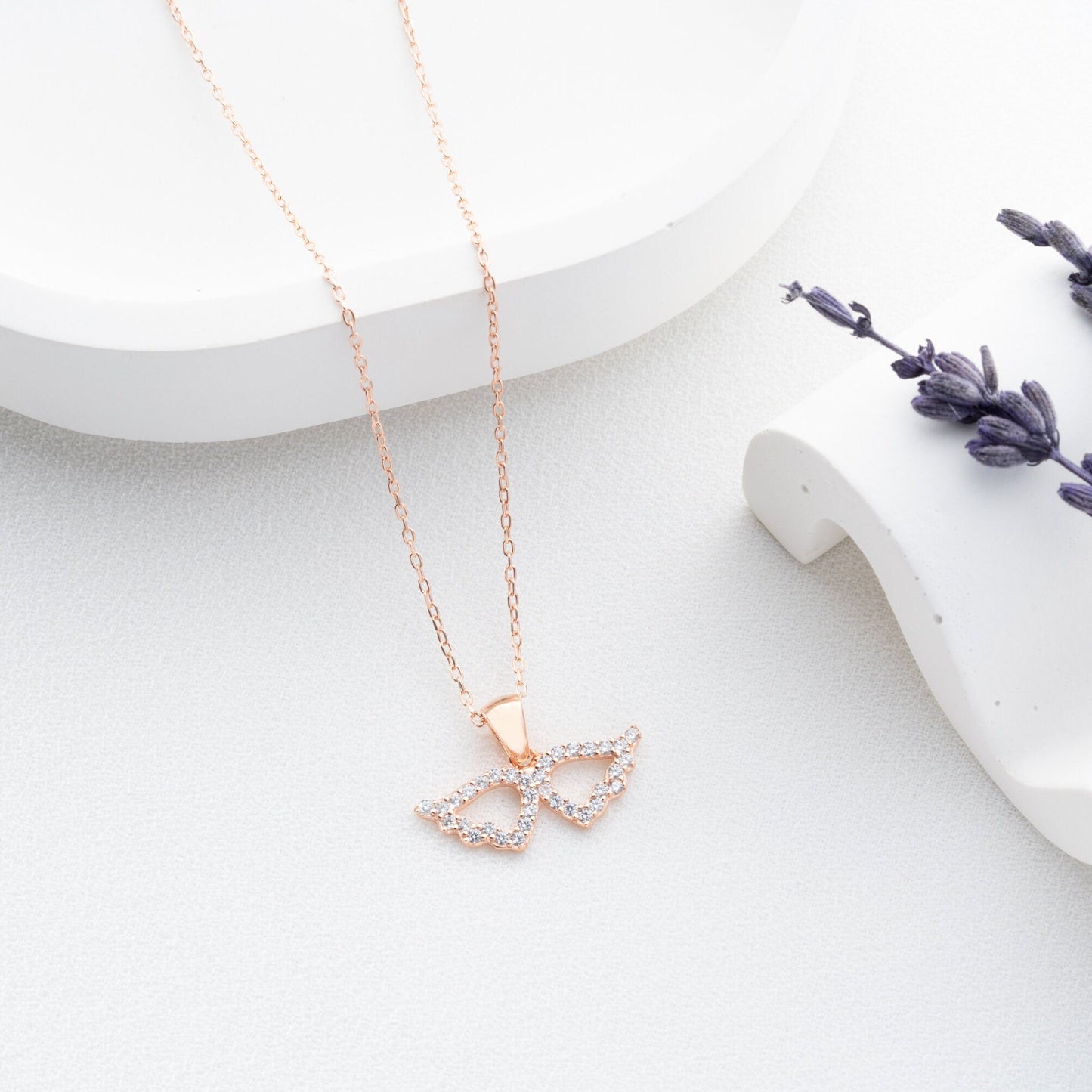 Elegant 925 sterling silver angel wing necklace, adorned with sparkling zircon stones, ideal as a protective charm or Mother's Day gift.