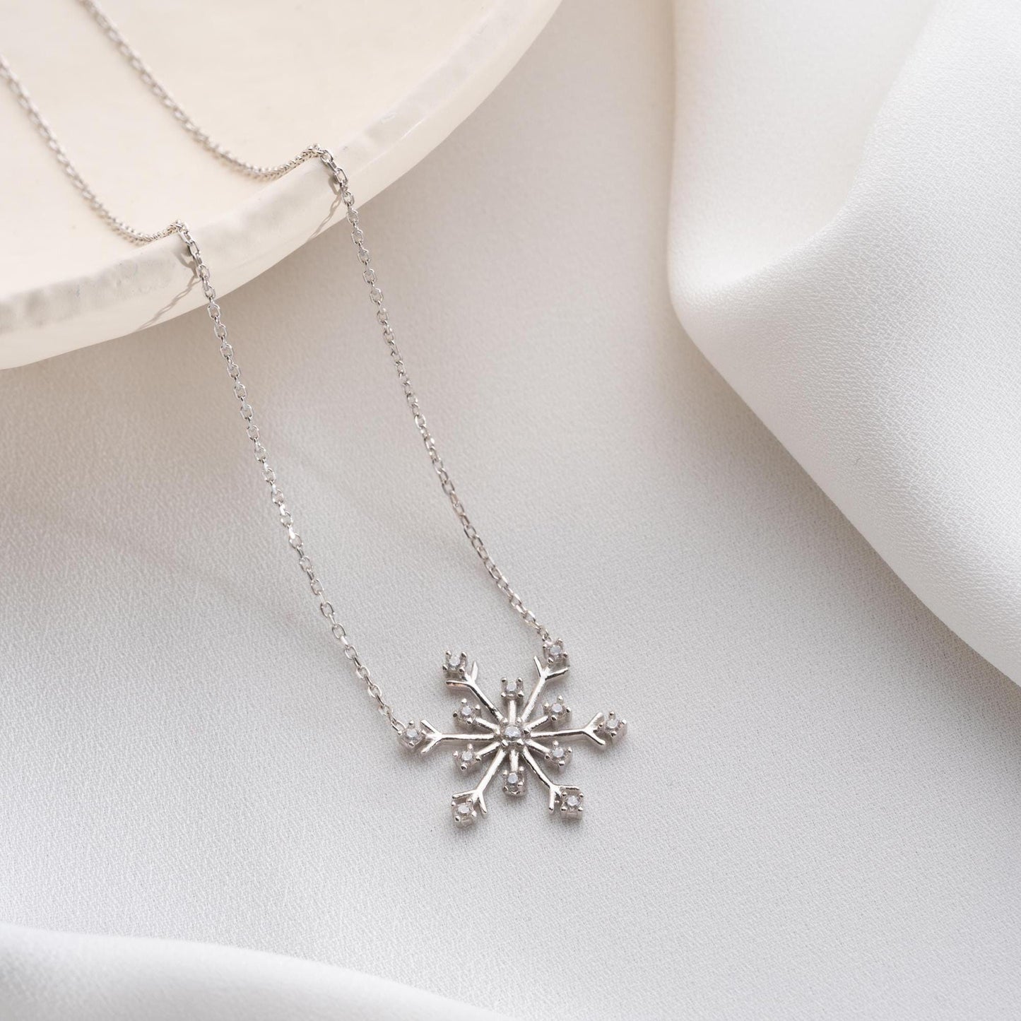 Snowflake necklace with cubic zirconia stones, perfect for Christmas, available in 925 sterling silver and 14K gold plated options.