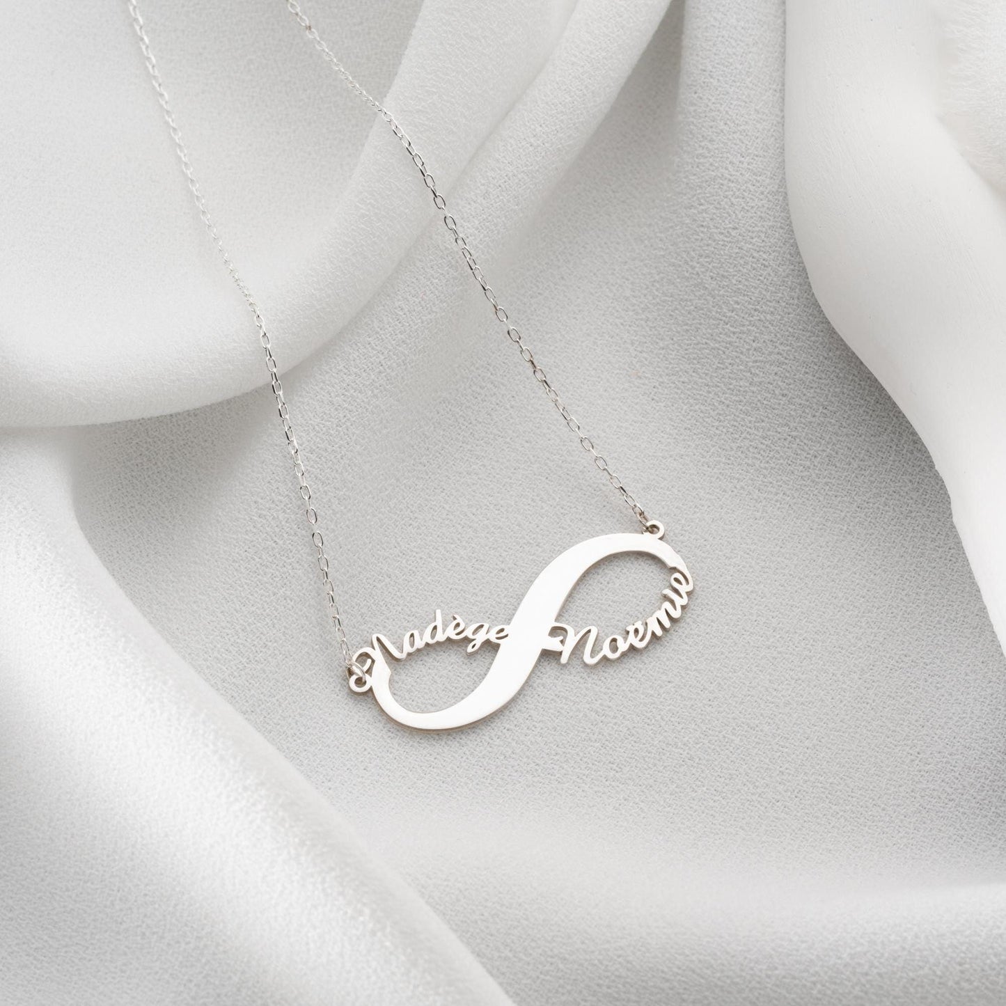 Custom infinity necklace with two personalized names, crafted in 925 sterling silver and 14k gold plated options. A timeless symbol of eternal love and unity.