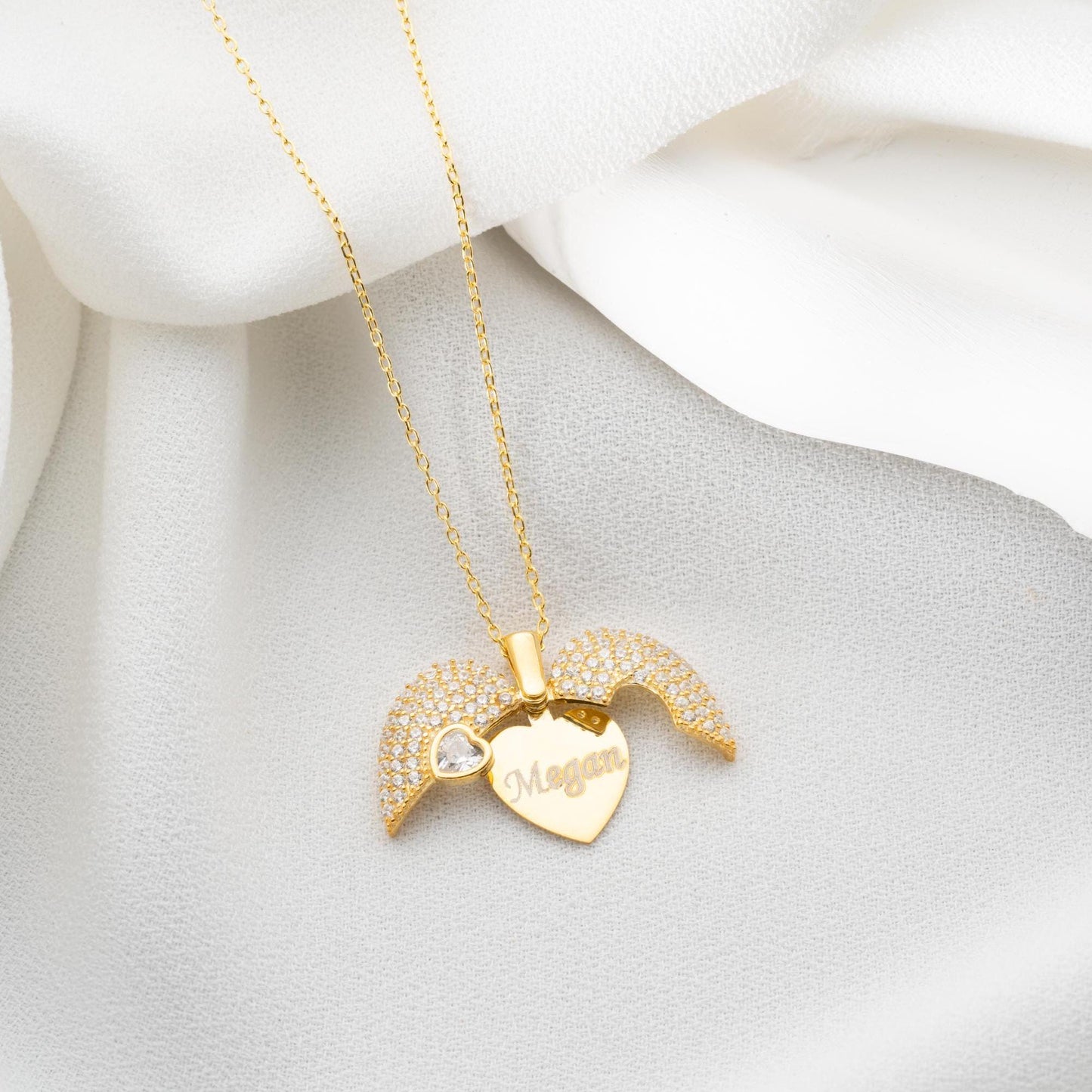 Personalized heart necklace with angel wings and name engraving, available in 925 sterling silver, 14k gold, and rose gold plated options. A meaningful, handmade jewelry gift for loved ones.
