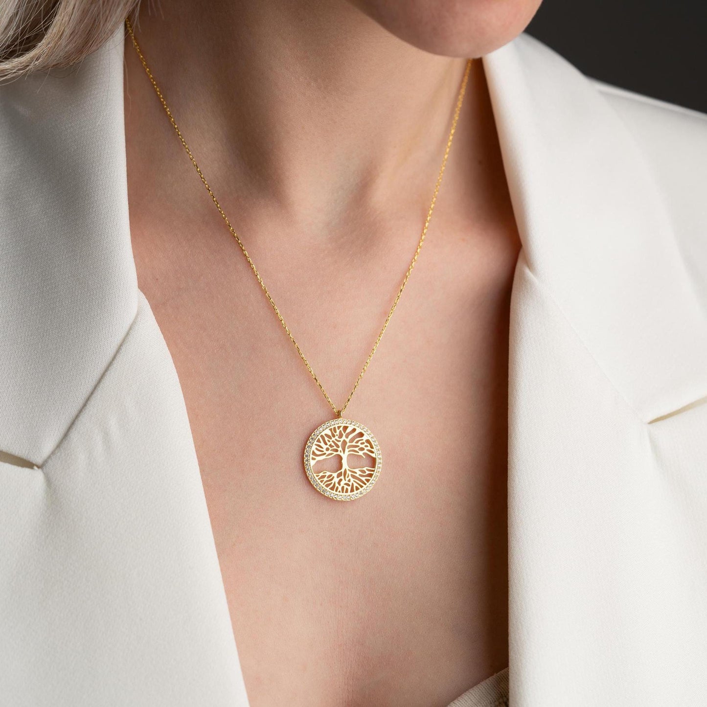 Tree of Life necklace with cubic zirconia stones, available in 925 sterling silver and 14K gold plated options, displayed on a white satin background.
