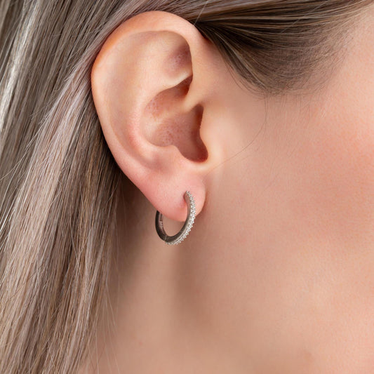 Minimalist hoop earrings with cubic zirconia stones in 925 sterling silver and 14K gold plated options, displayed on a neutral background.