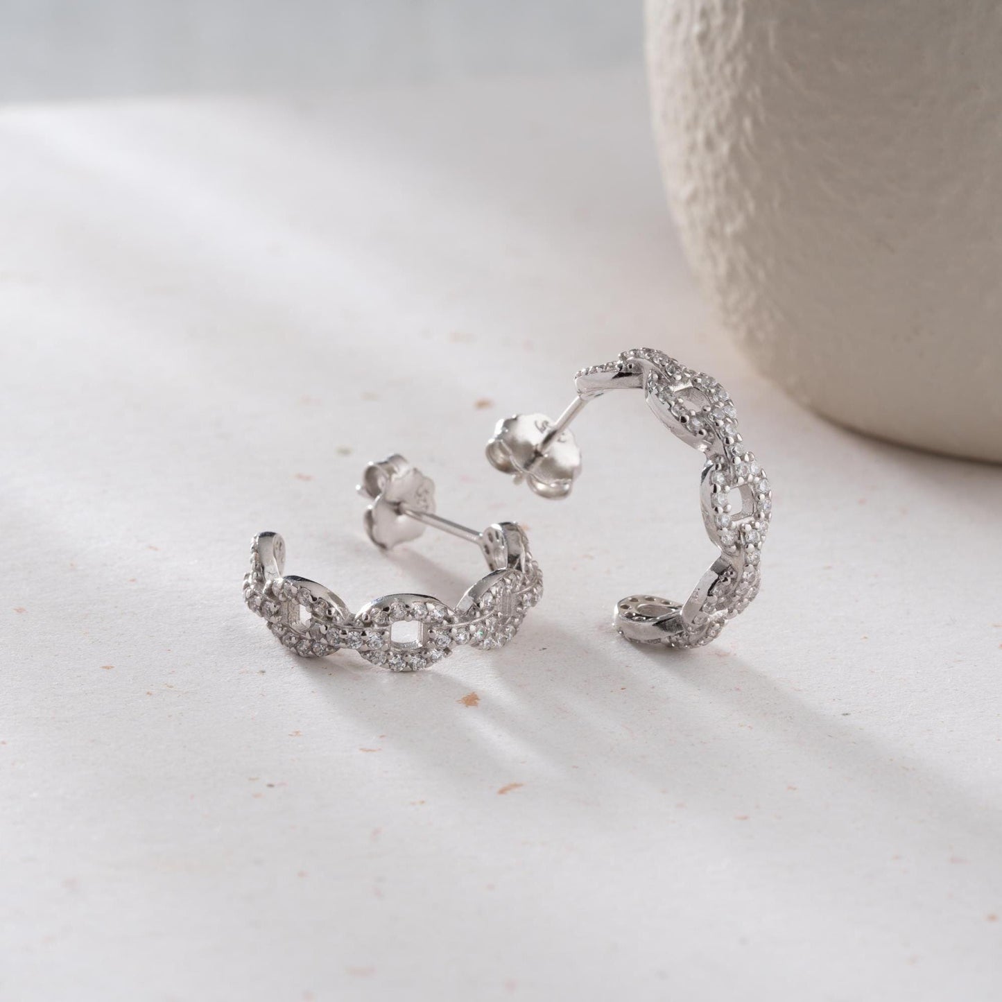 Chain link hoop earrings in 925 sterling silver with 14K gold plated option, adorned with sparkling cubic zirconia stones, ideal for gifting.