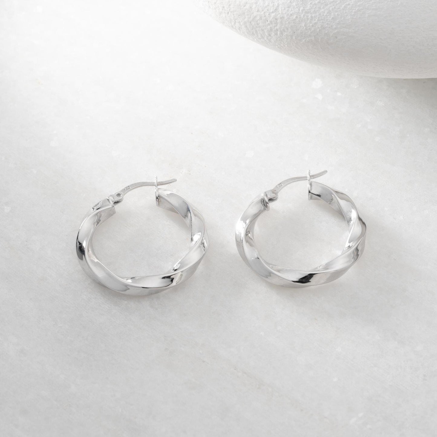 Twisted hoop earrings crafted from 925 sterling silver with a 14K gold-plated option, featuring a lever back closure, perfect for Christmas gifting and everyday wear.