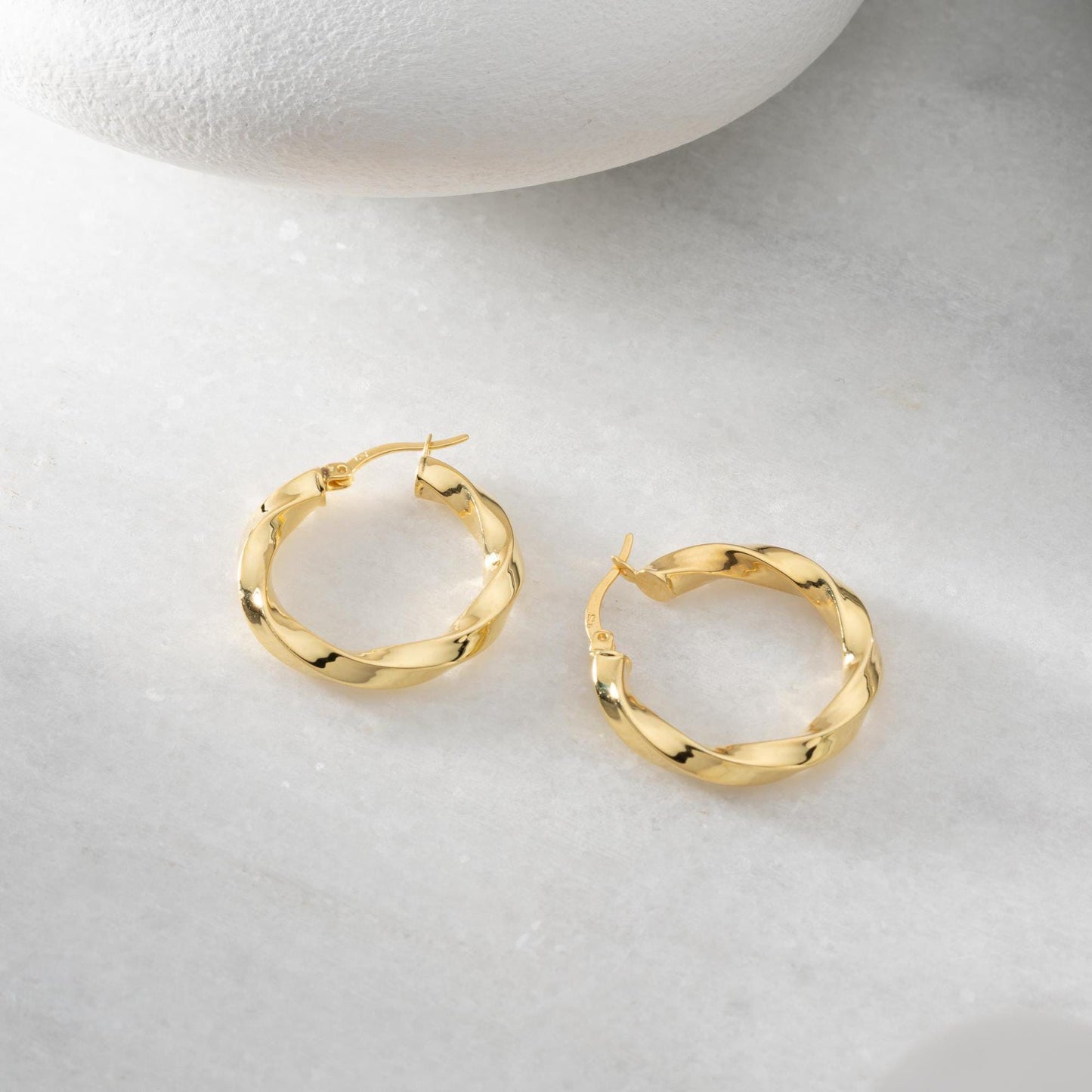 Twisted hoop earrings crafted from 925 sterling silver with a 14K gold-plated option, featuring a lever back closure, perfect for Christmas gifting and everyday wear.