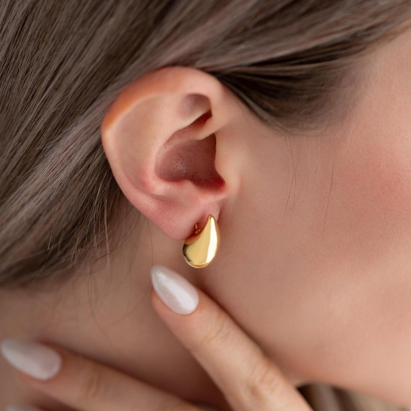 Teardrop-shaped stud earrings crafted from 925 sterling silver with a 14K gold-plated option, featuring a push back closure, perfect for Christmas gifting and everyday wear.