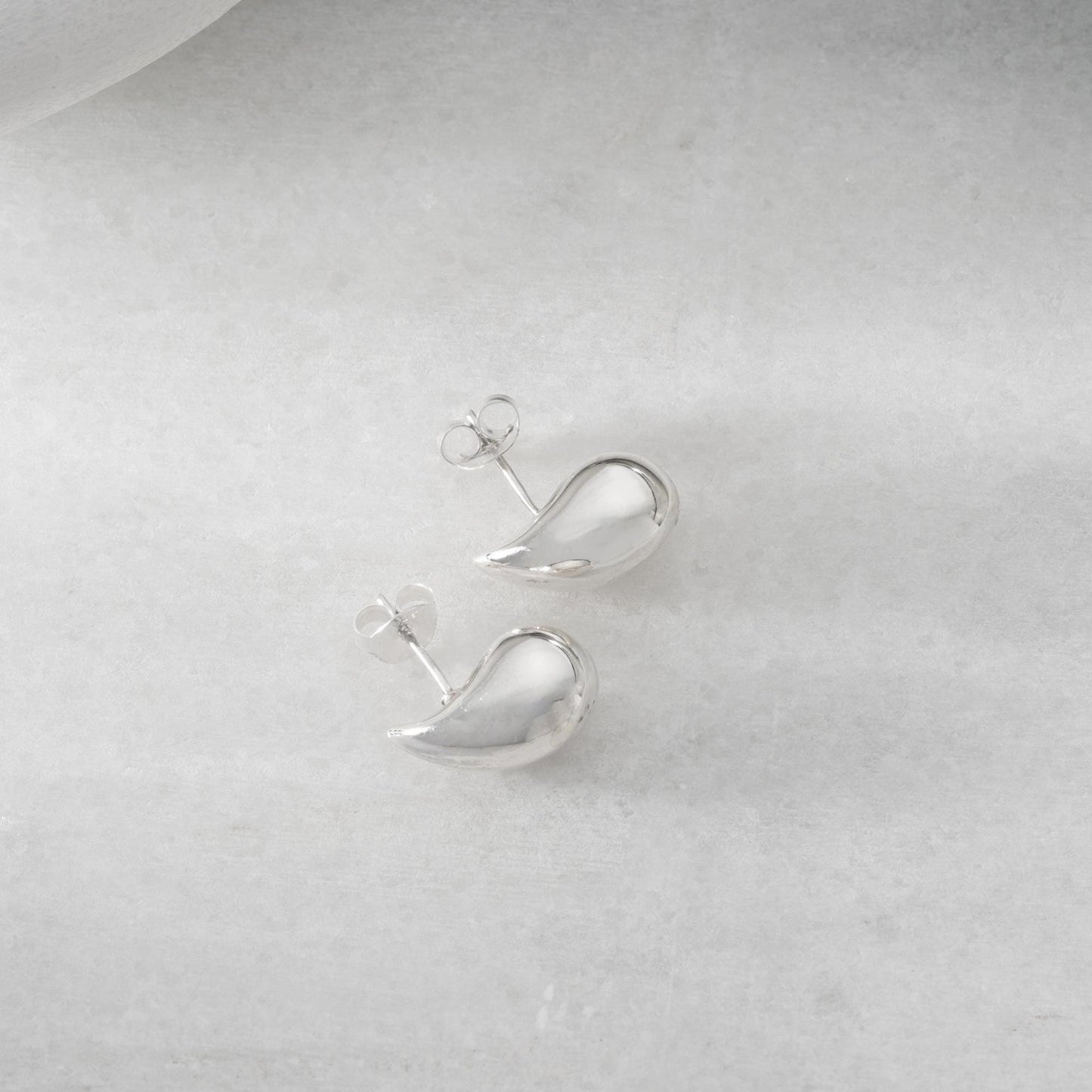Teardrop-shaped stud earrings crafted from 925 sterling silver with a 14K gold-plated option, featuring a push back closure, perfect for Christmas gifting and everyday wear.