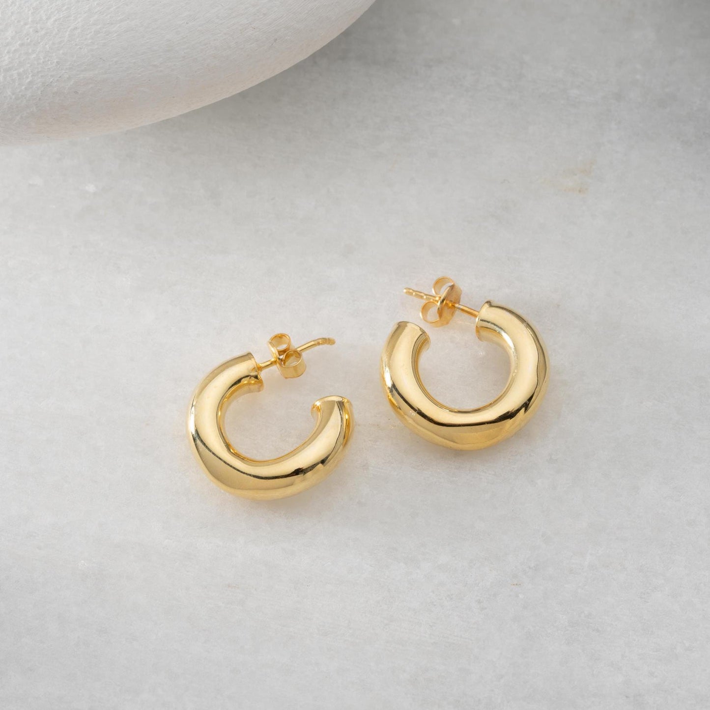Chunky hoop earrings crafted from 925 sterling silver with a 14K gold-plated option, perfect for a minimalist yet bold look.