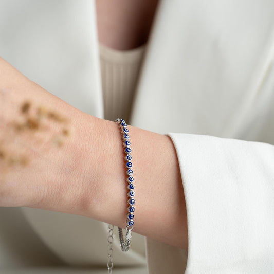 Evil eye bracelet crafted from 925 sterling silver with a 14K gold-plated option, featuring protective and stylish evil eye charms.
