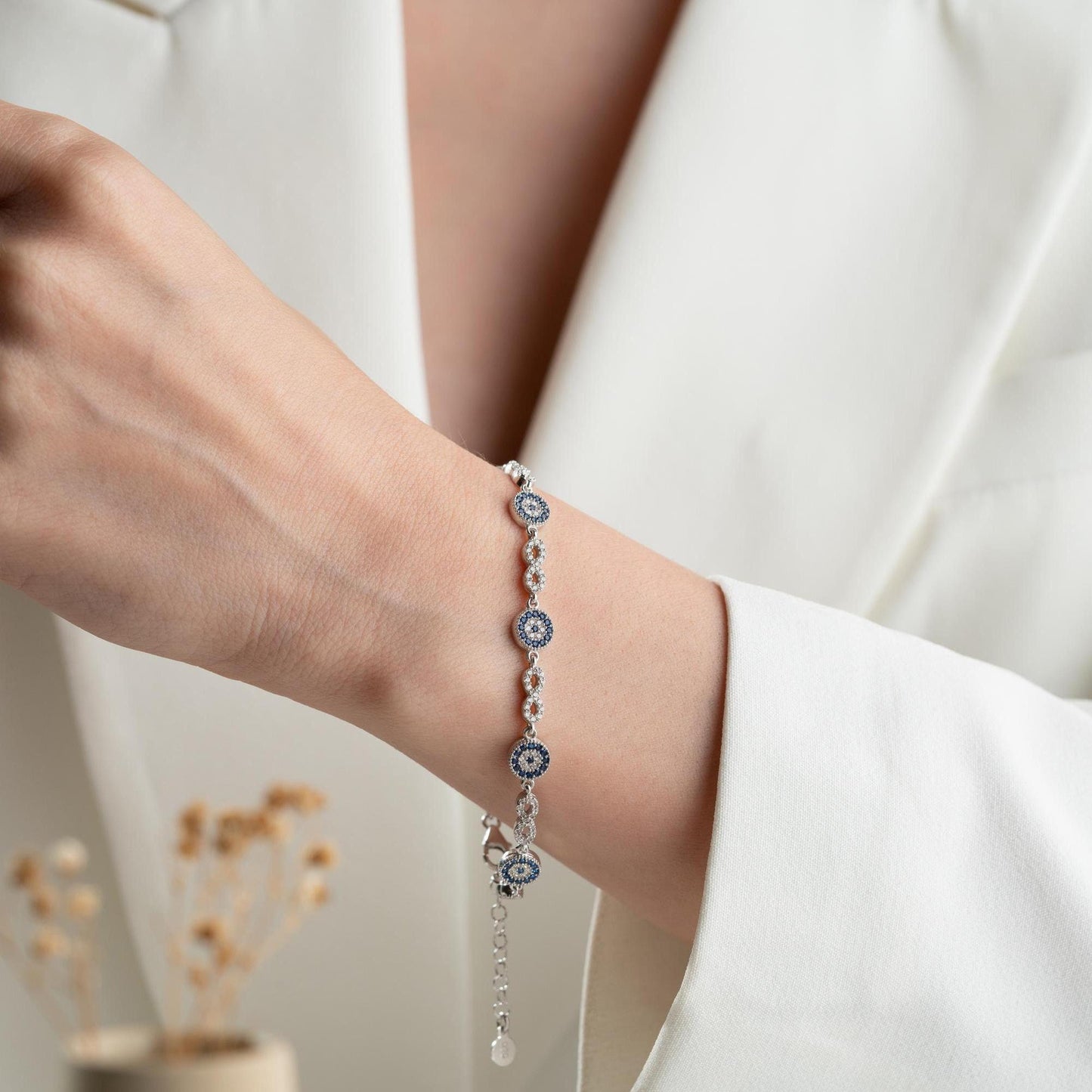 Infinity Evil Eye Bracelet with 925 Sterling Silver and 14K Gold Plated options, featuring blue evil eye accents, photographed in gold and silver variations.