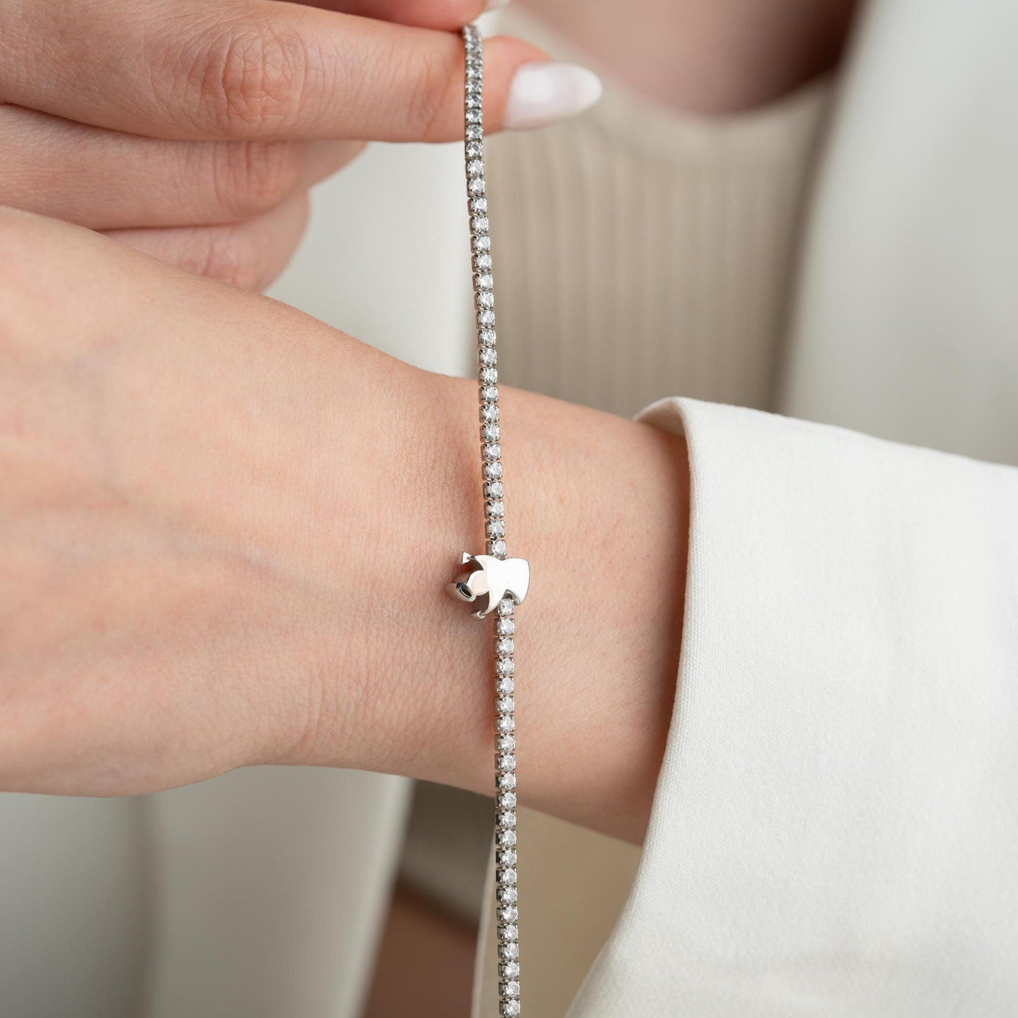 Angel Charm Bracelet in 925 Sterling Silver with a 14K Gold Plated angel charm and cubic zirconia stones, elegantly displayed.