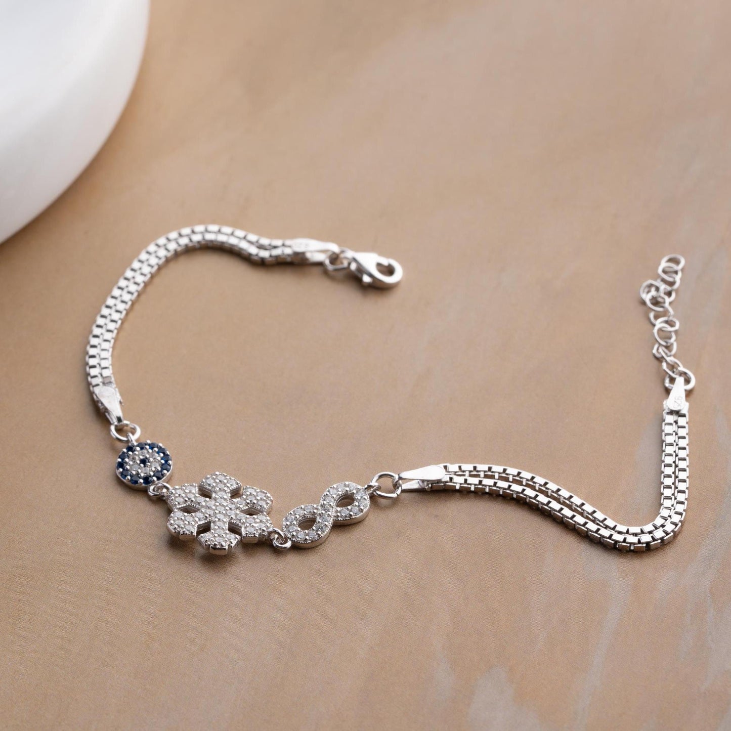Double chain bracelet with snowflake, infinity, and evil eye charms, crafted in 925 Sterling Silver and 14K Gold Plated, perfect for Christmas or special occasions.