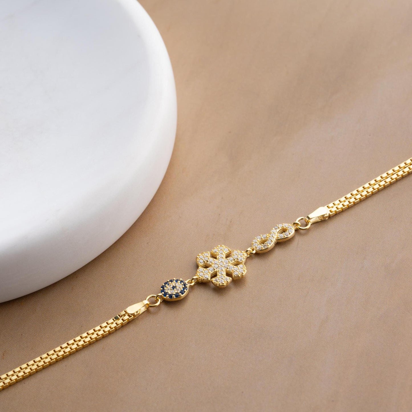 Double chain bracelet with snowflake, infinity, and evil eye charms, crafted in 925 Sterling Silver and 14K Gold Plated, perfect for Christmas or special occasions.