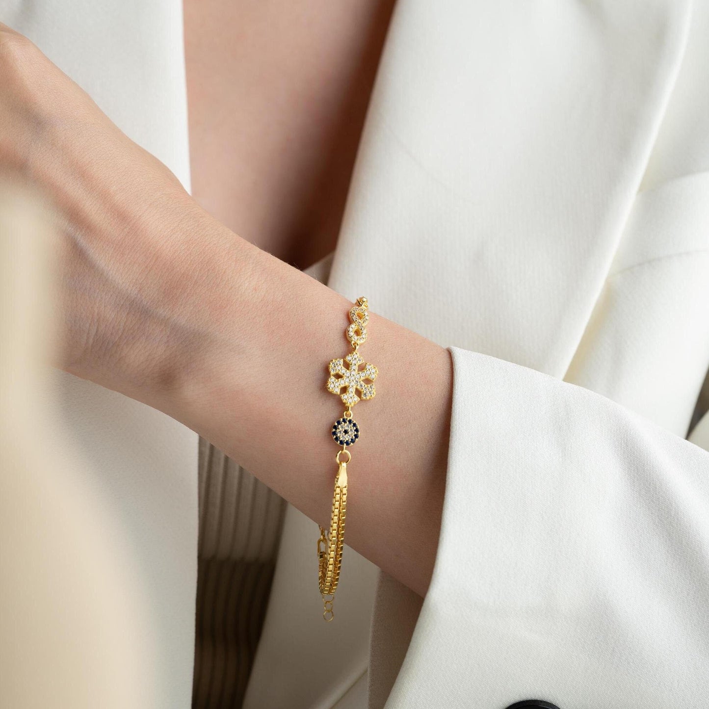 Double chain bracelet with snowflake, infinity, and evil eye charms, crafted in 925 Sterling Silver and 14K Gold Plated, perfect for Christmas or special occasions.