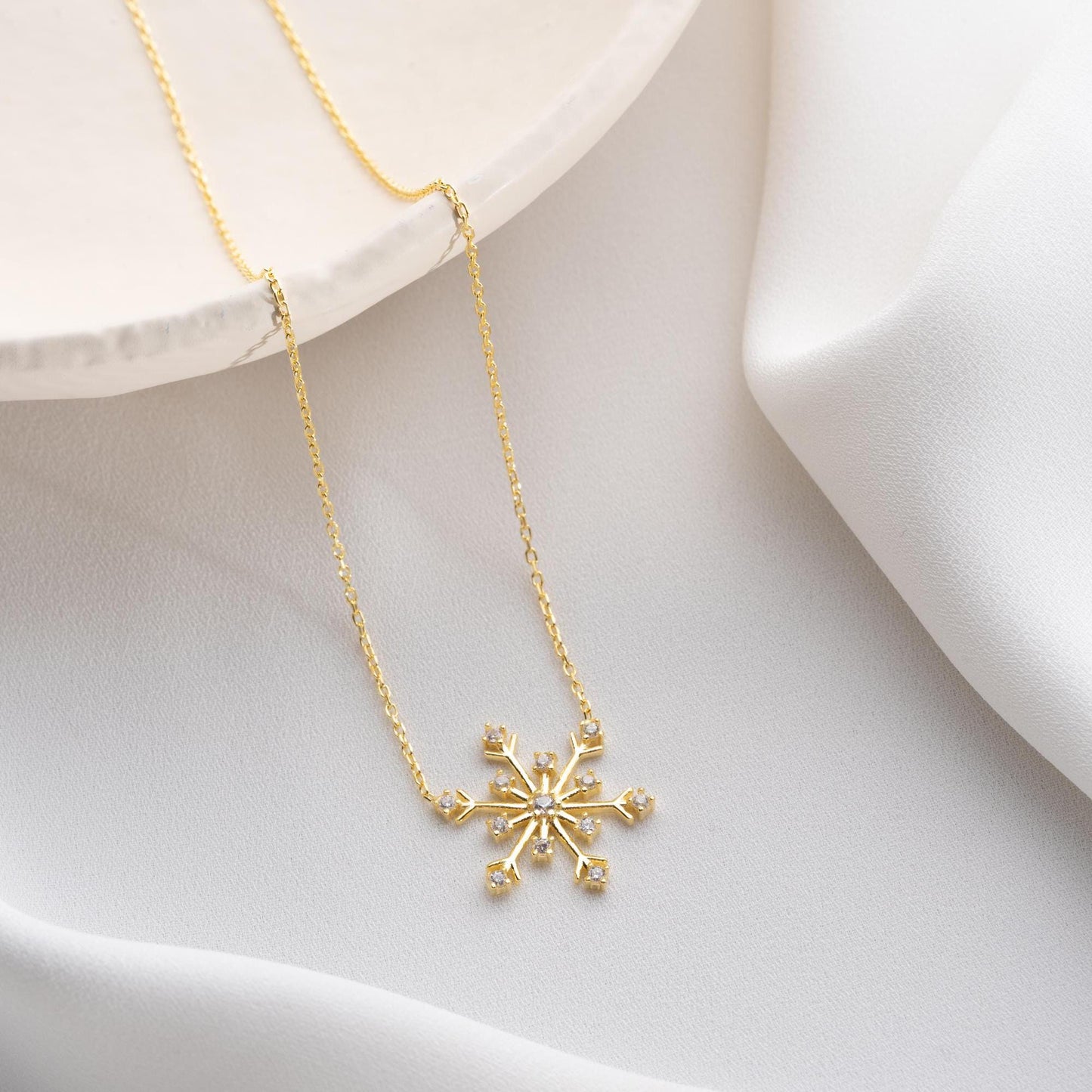 Snowflake necklace with cubic zirconia stones, perfect for Christmas, available in 925 sterling silver and 14K gold plated options.