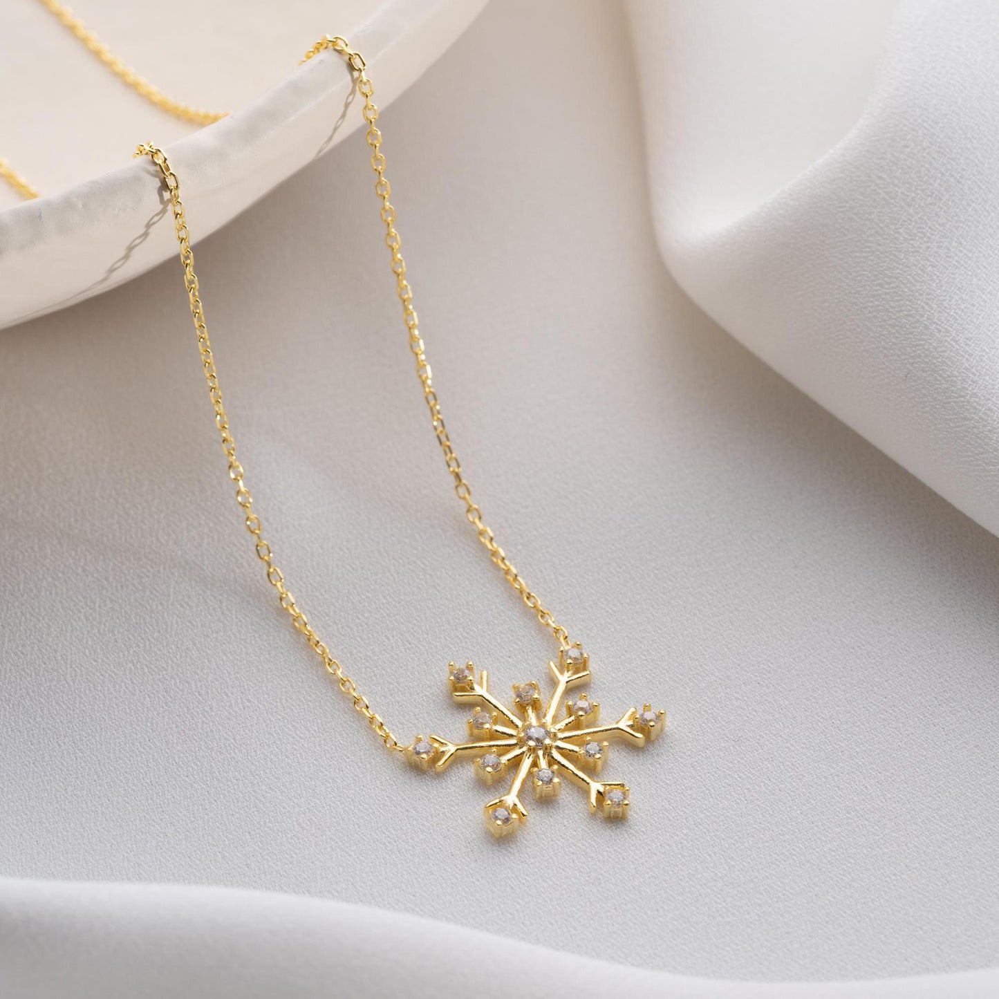 Snowflake necklace with cubic zirconia stones, perfect for Christmas, available in 925 sterling silver and 14K gold plated options.