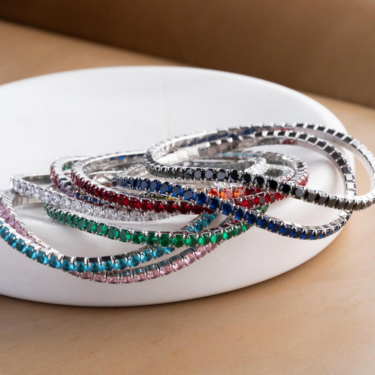 Vibrant stackable tennis bracelet set featuring multicolored cubic zirconia stones, crafted in 925 Sterling Silver with a 14K Gold Plated option, perfect for festive and everyday wear.