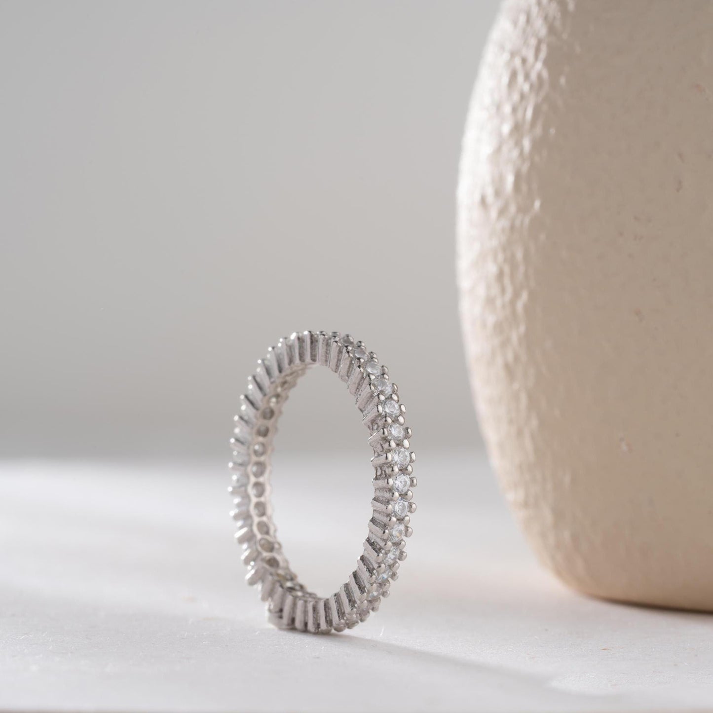 Elegant white zircon tennis ring made from 925 Sterling Silver, with brilliant stones set around the entire band. Adjustable and hypoallergenic.