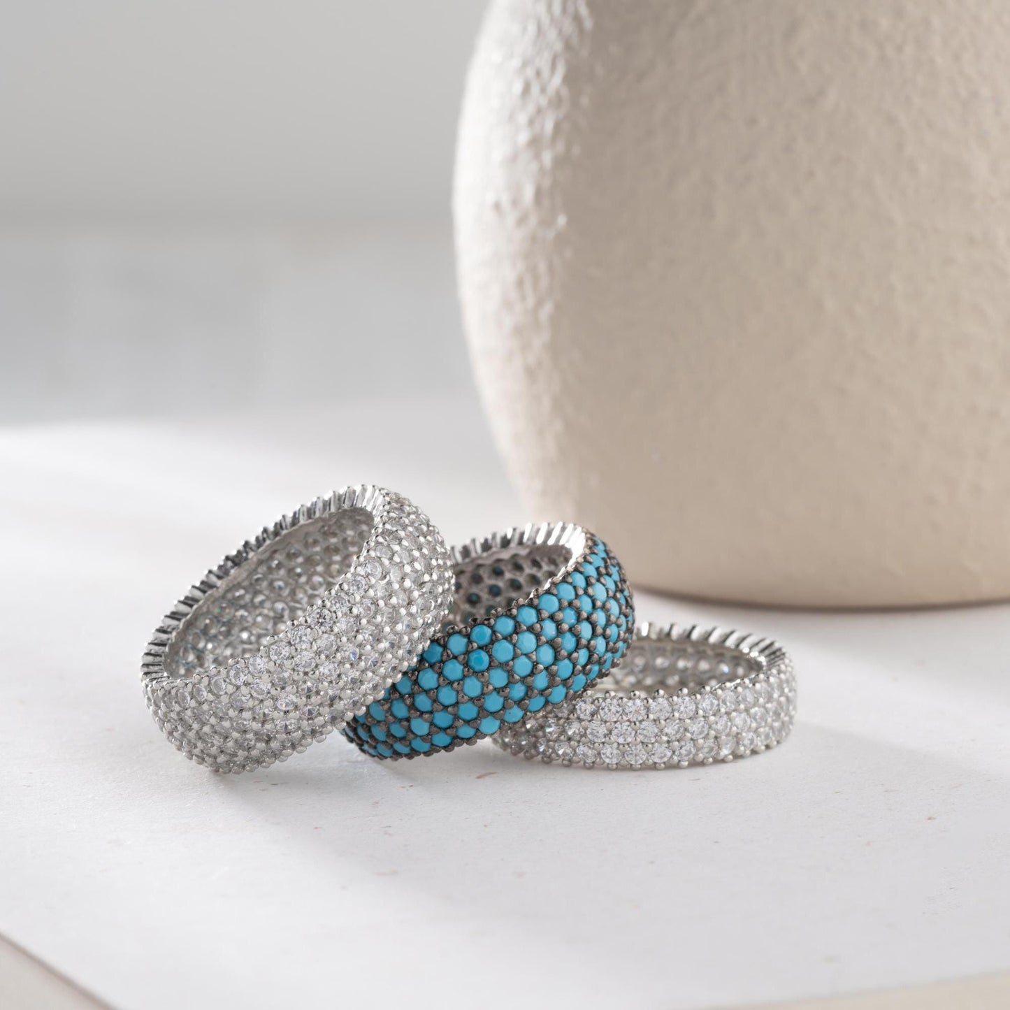 Full eternity band ring featuring pave cubic zirconia stones in clear and turquoise options, set in 925 sterling silver. A versatile, stackable piece perfect for gifting or personal wear.