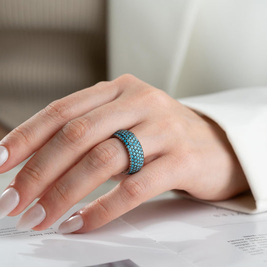 Full eternity band ring featuring pave cubic zirconia stones in clear and turquoise options, set in 925 sterling silver. A versatile, stackable piece perfect for gifting or personal wear.