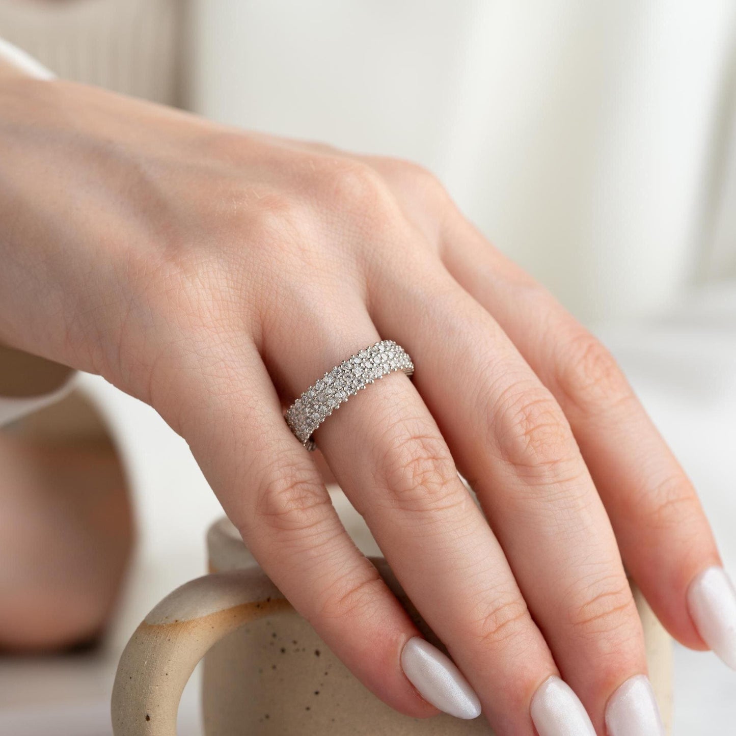 Full eternity band ring featuring pave cubic zirconia stones in clear and turquoise options, set in 925 sterling silver. A versatile, stackable piece perfect for gifting or personal wear.