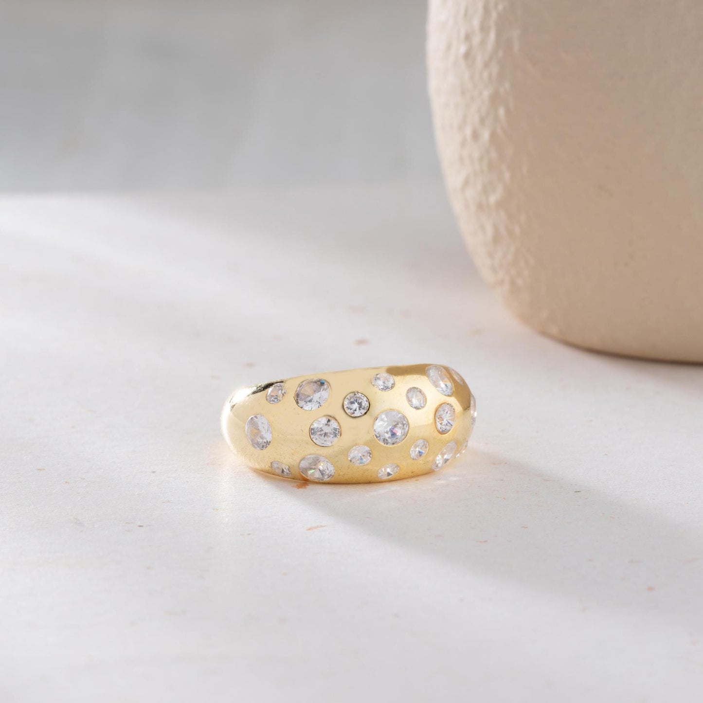 Elegant pave dome ring featuring dazzling cubic zirconia stones, crafted in 925 sterling silver with 14K gold plated options. A luxurious, adjustable statement ring for women.