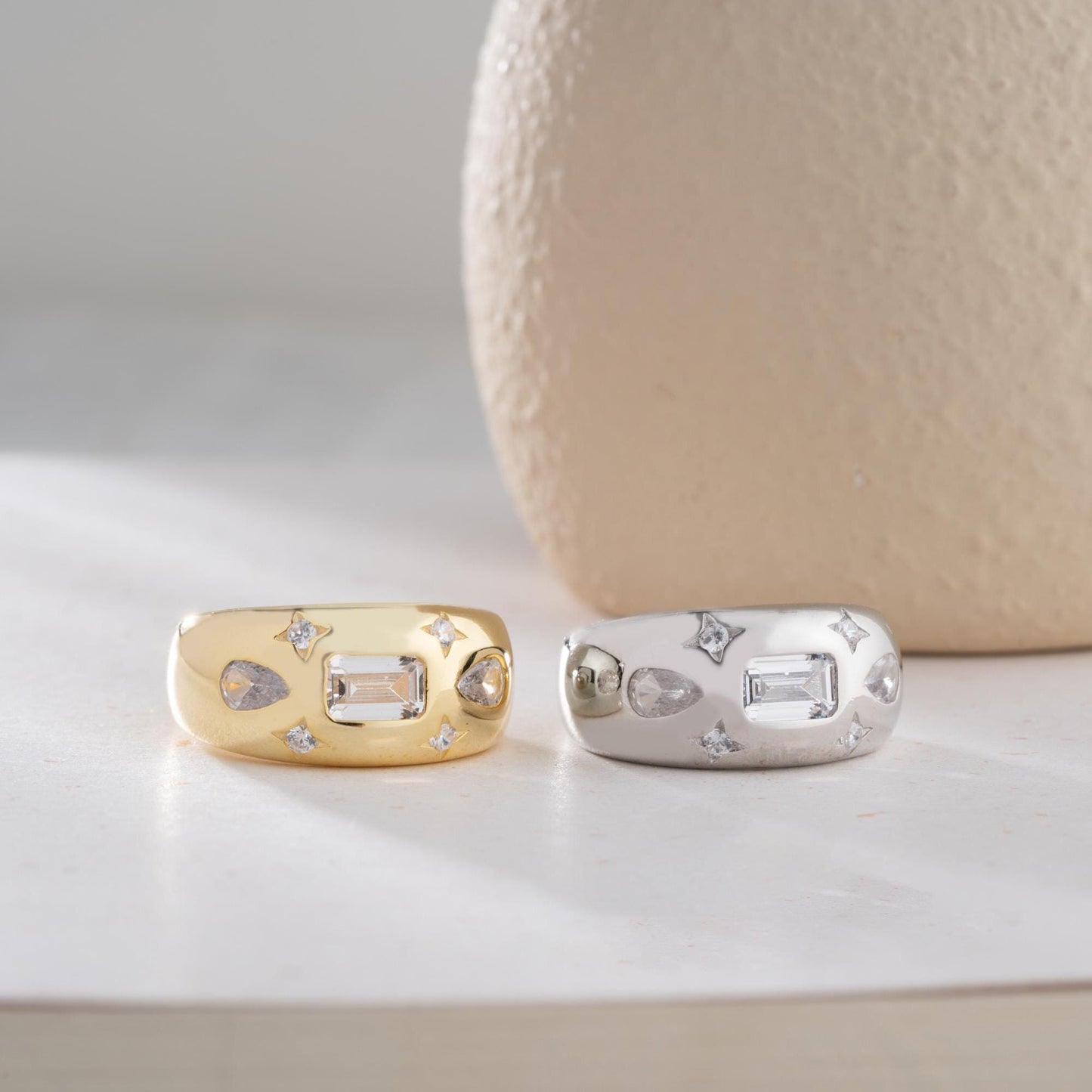 Baguette and teardrop cubic zirconia band ring in 925 sterling silver and 14K gold plating, featuring celestial star motifs. Elegant statement ring for women.