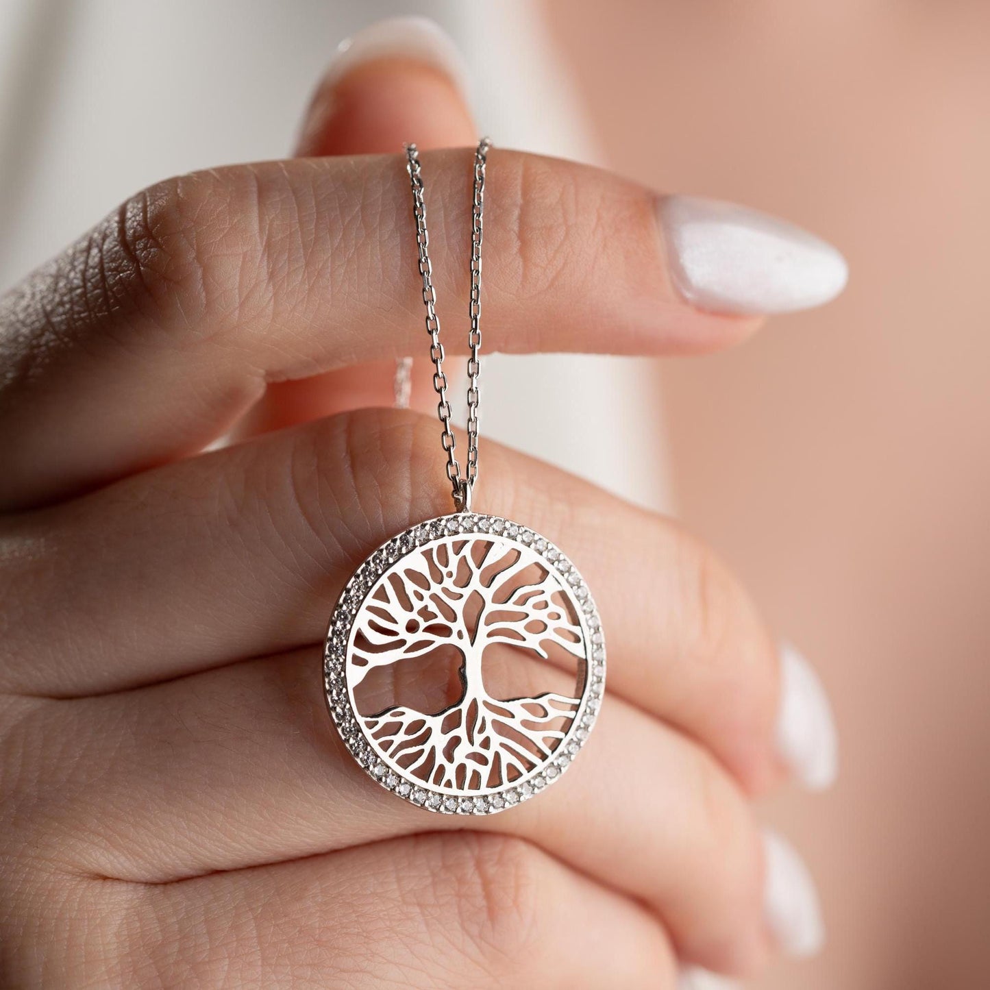 Tree of Life necklace with cubic zirconia stones, available in 925 sterling silver and 14K gold plated options, displayed on a white satin background.