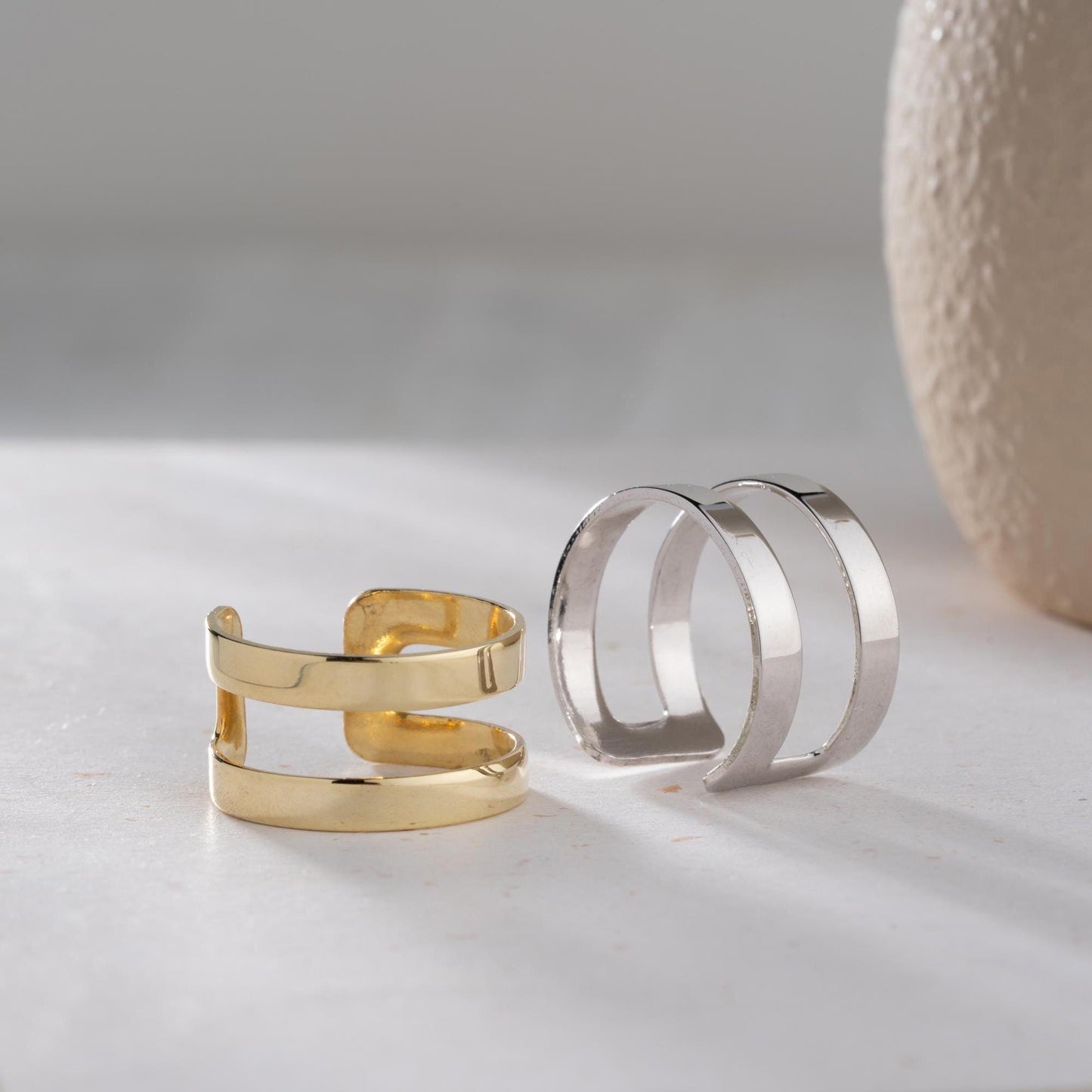 A sleek minimalist double-band ring, handcrafted from 925 sterling silver with 14K gold and rose gold plated options. A perfect stackable jewelry piece for everyday wear or as a gift for her.
