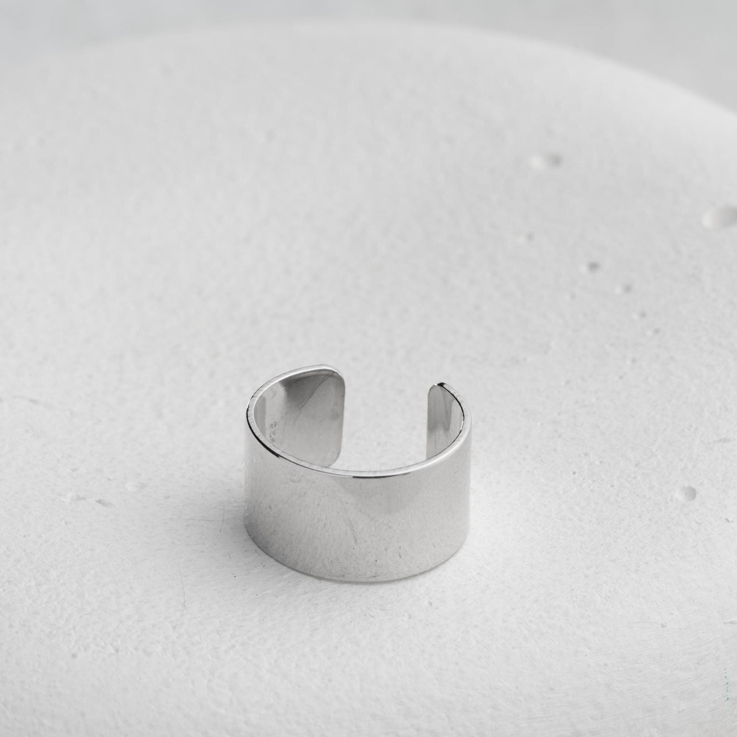 A bold, wide band open ring crafted from 925 Sterling Silver, available in gold and rose gold finishes. Adjustable design for comfort and style, ideal for gifting.