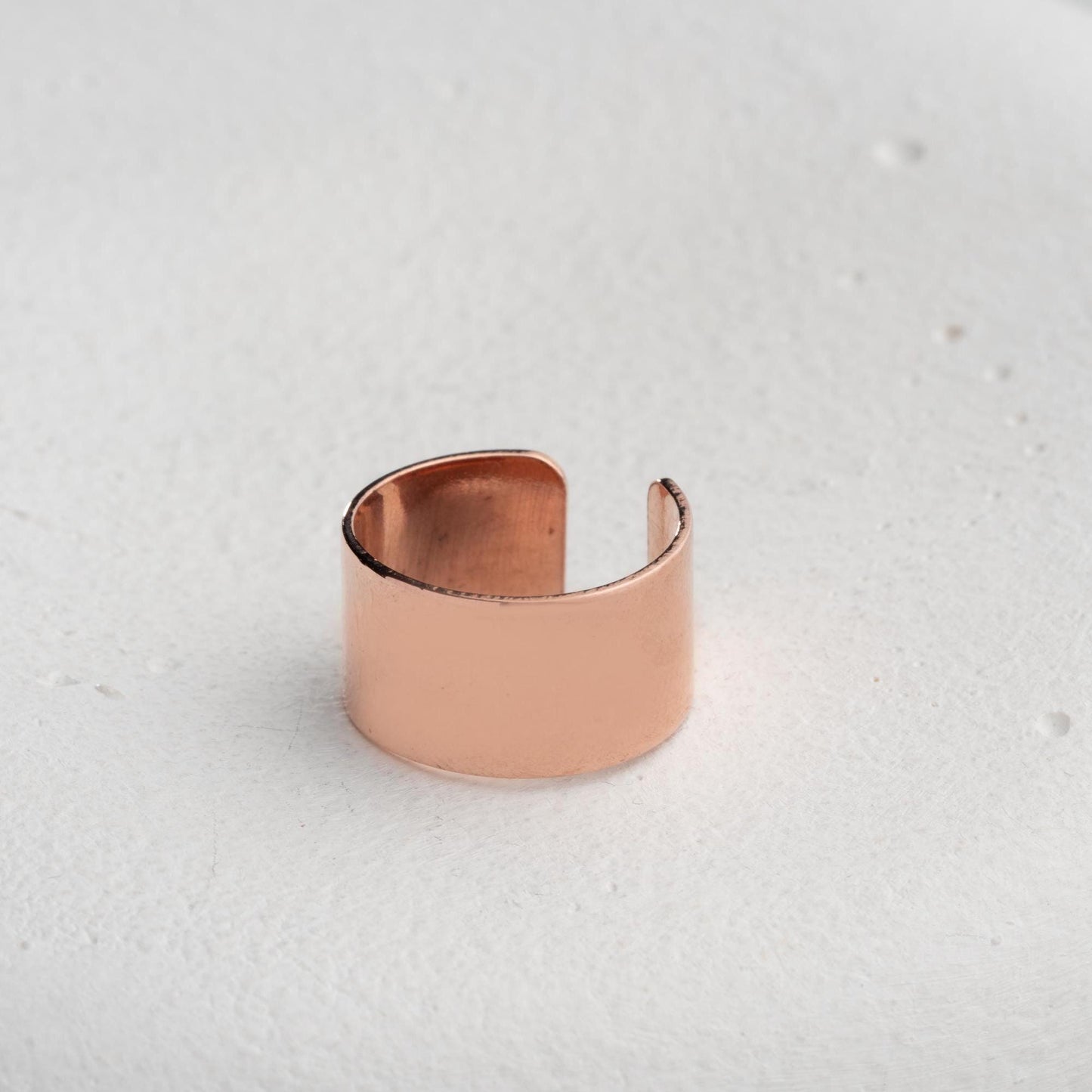 A bold, wide band open ring crafted from 925 Sterling Silver, available in gold and rose gold finishes. Adjustable design for comfort and style, ideal for gifting.