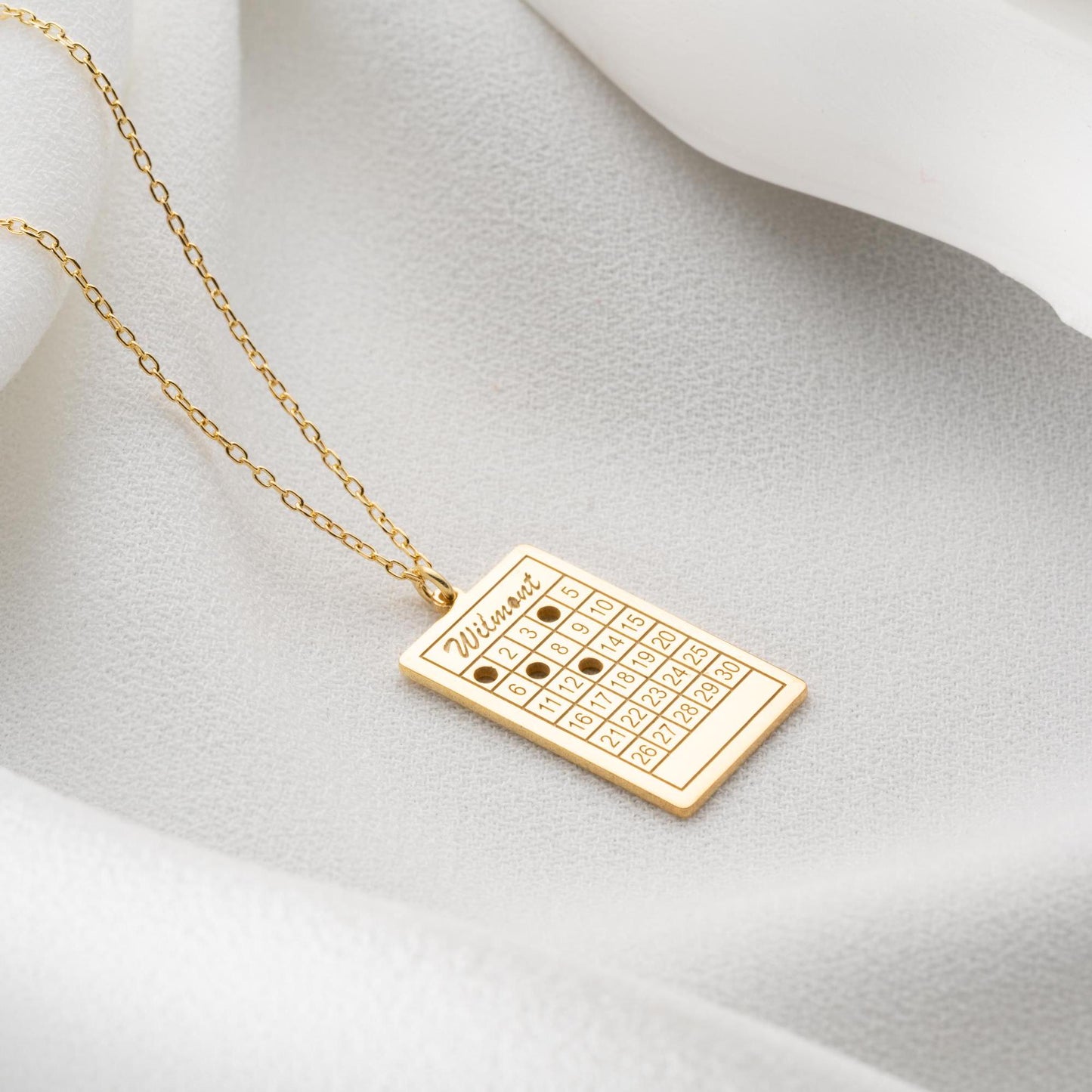 A rectangular calendar pendant necklace, engraved with a custom date and name, crafted from 925 Sterling Silver or 14K Gold Plated. Ideal for anniversaries, weddings, and birthday gifts.