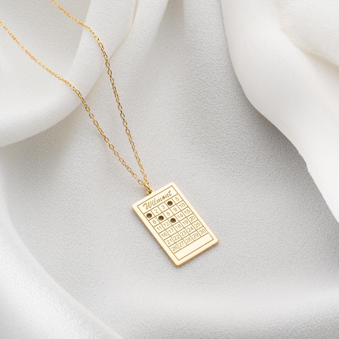 A rectangular calendar pendant necklace, engraved with a custom date and name, crafted from 925 Sterling Silver or 14K Gold Plated. Ideal for anniversaries, weddings, and birthday gifts.