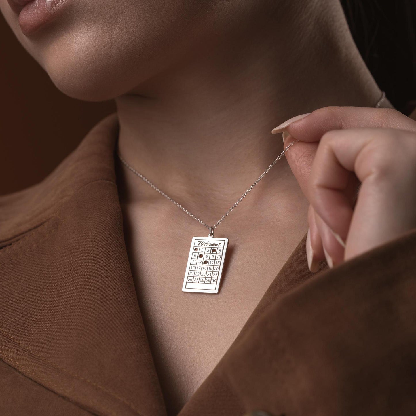 A rectangular calendar pendant necklace, engraved with a custom date and name, crafted from 925 Sterling Silver or 14K Gold Plated. Ideal for anniversaries, weddings, and birthday gifts.