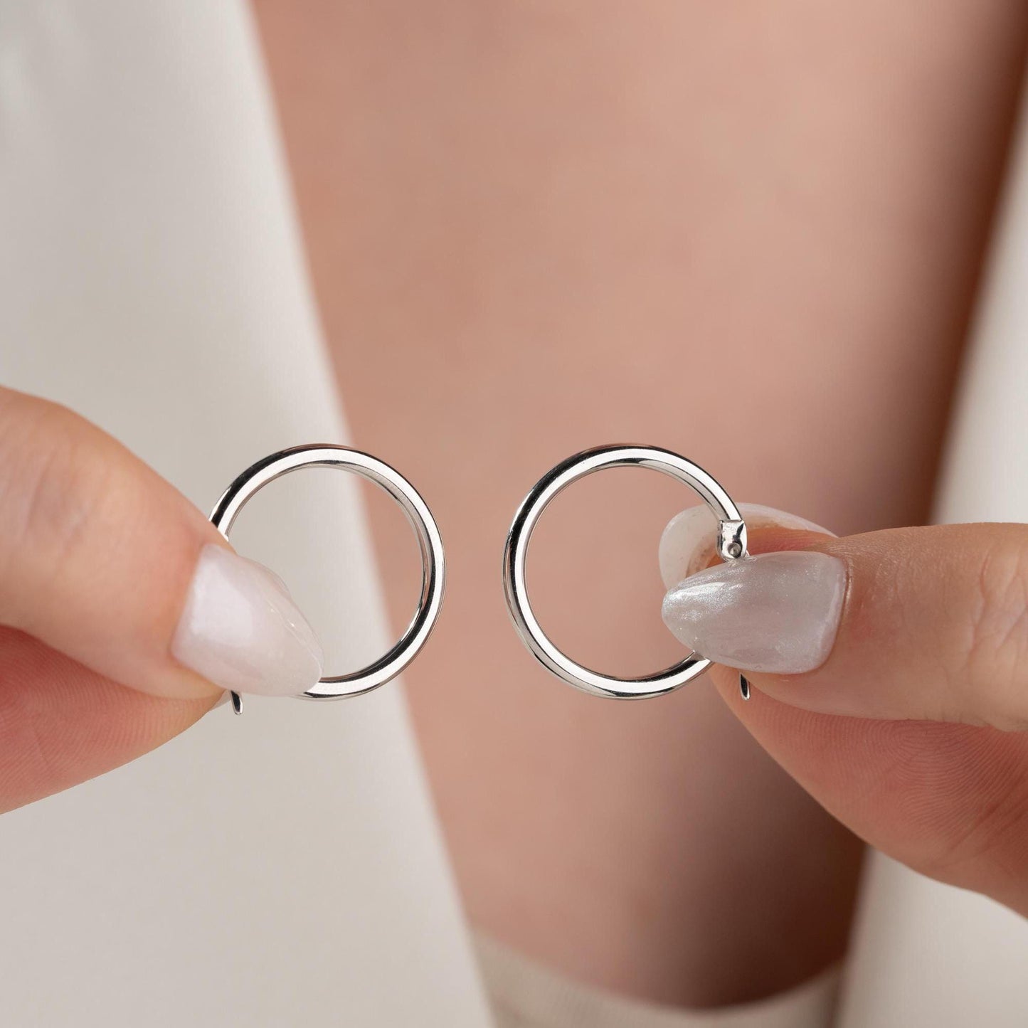 classic hoop earrings in 925 sterling silver and 14K gold plated options, featuring a minimalist polished design displayed on a marble background