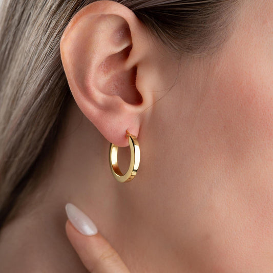 Thick hoop earrings in 925 sterling silver and 14K gold plated options, perfect for minimalist and bold everyday style.