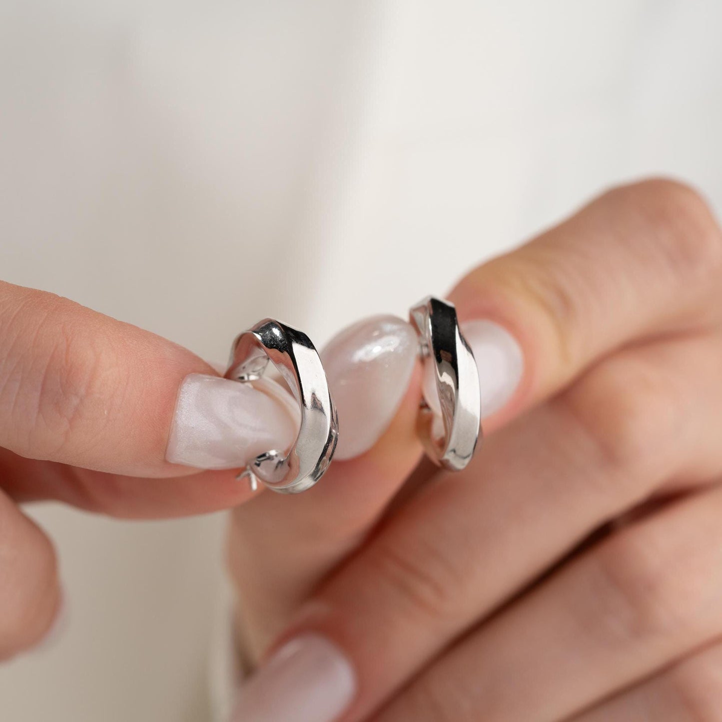 Twist hoop earrings in 925 Sterling Silver and 14K Gold Plated options, perfect for minimalist and elegant looks.