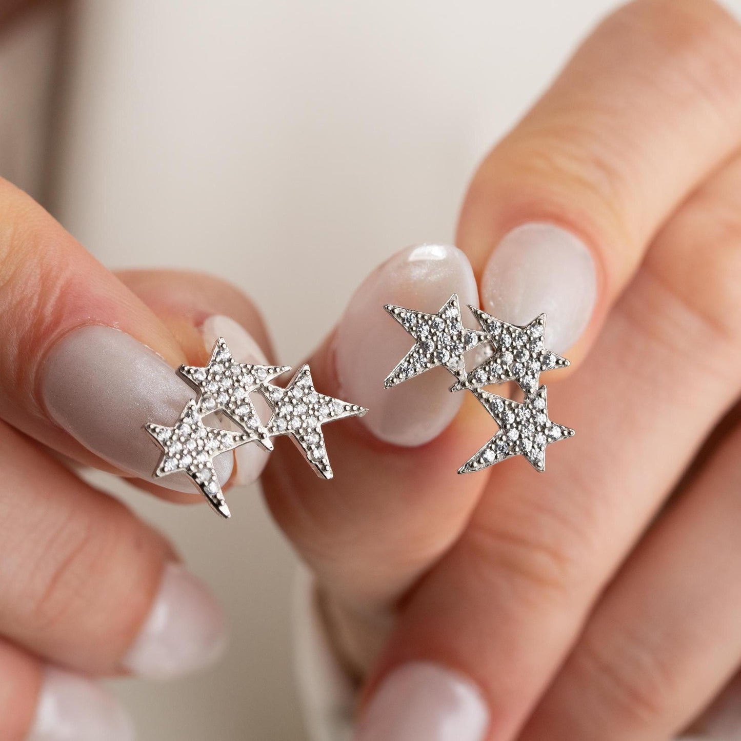 Star cluster earrings in 925 Sterling Silver and 14K Gold Plated options, adorned with cubic zirconia stones for an elegant holiday look.