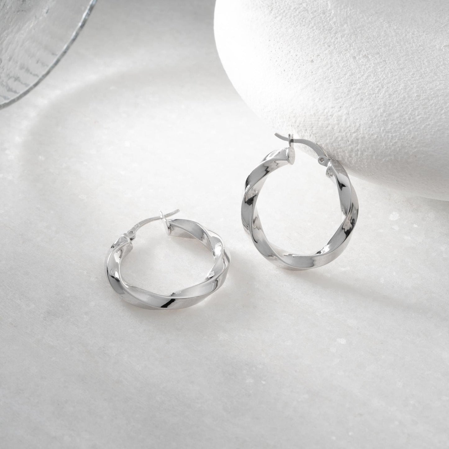 Twisted hoop earrings crafted from 925 sterling silver with a 14K gold-plated option, featuring a lever back closure, perfect for Christmas gifting and everyday wear.