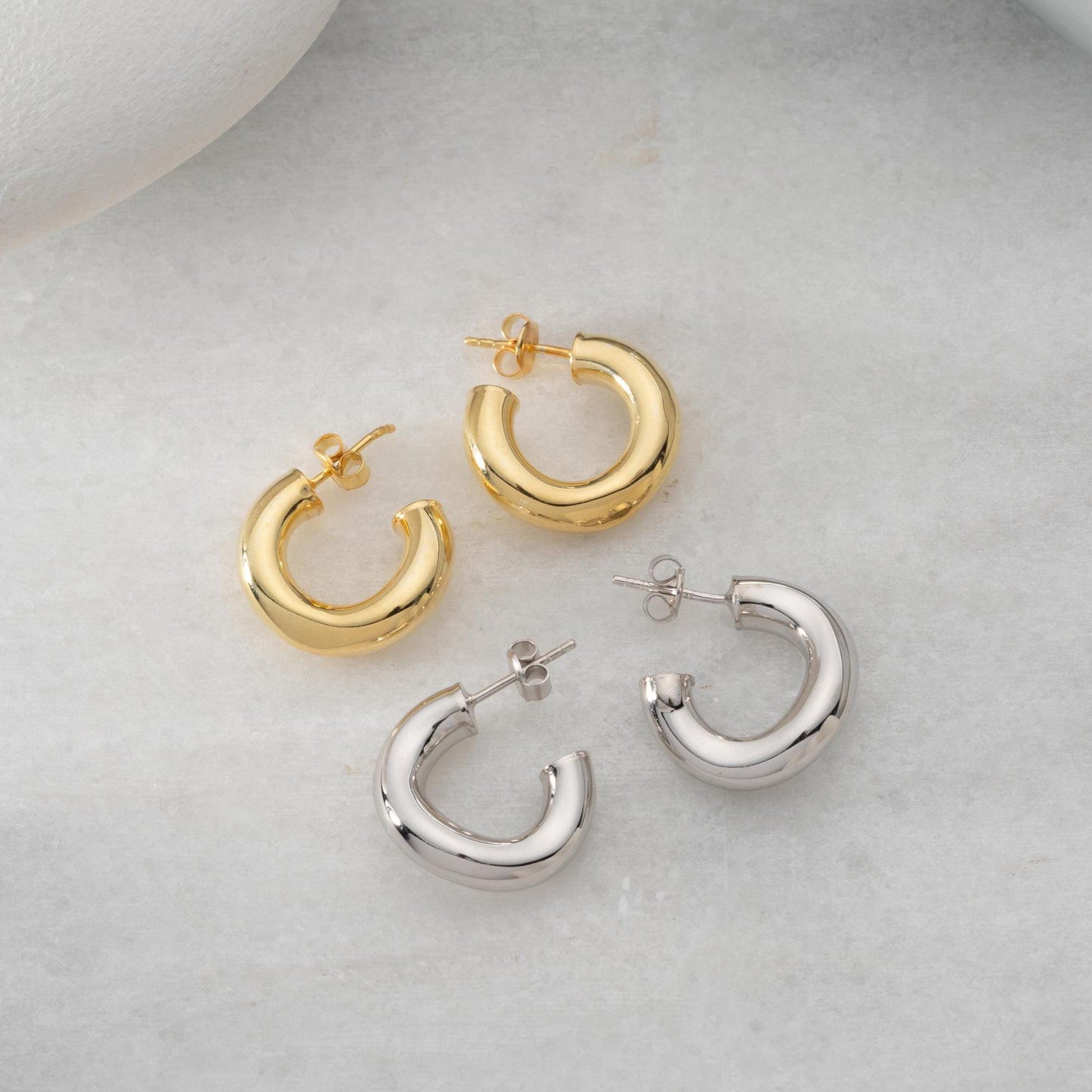 Chunky hoop earrings crafted from 925 sterling silver with a 14K gold-plated option, perfect for a minimalist yet bold look.