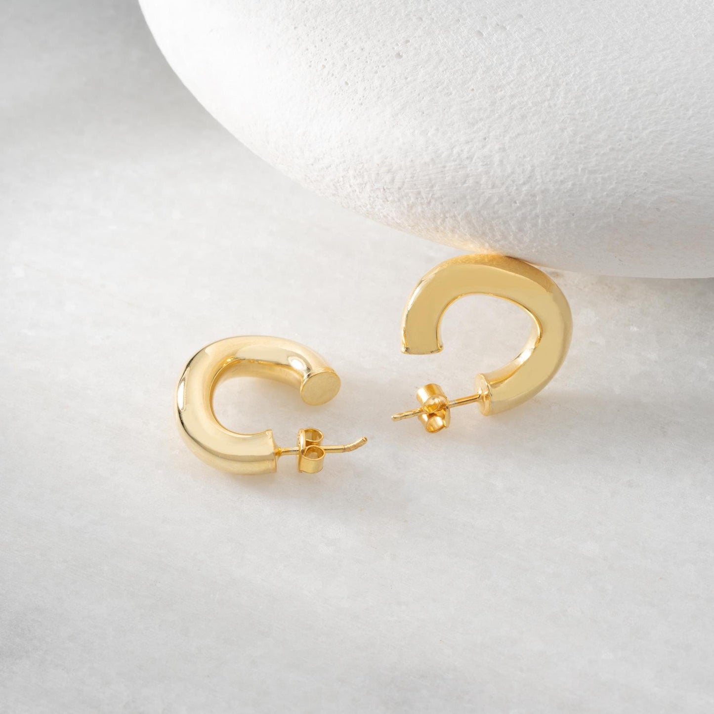 Chunky hoop earrings crafted from 925 sterling silver with a 14K gold-plated option, perfect for a minimalist yet bold look.