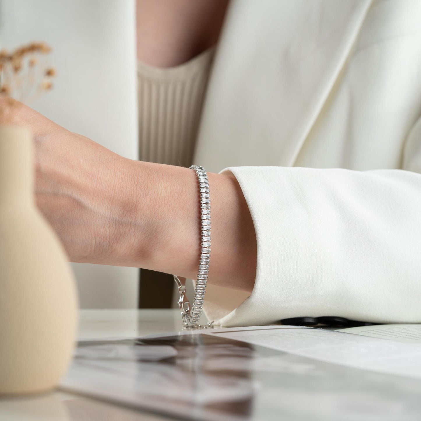 Luxurious baguette cut bracelet crafted in 925 Sterling Silver with cubic zirconia stones, available in silver and gold options.