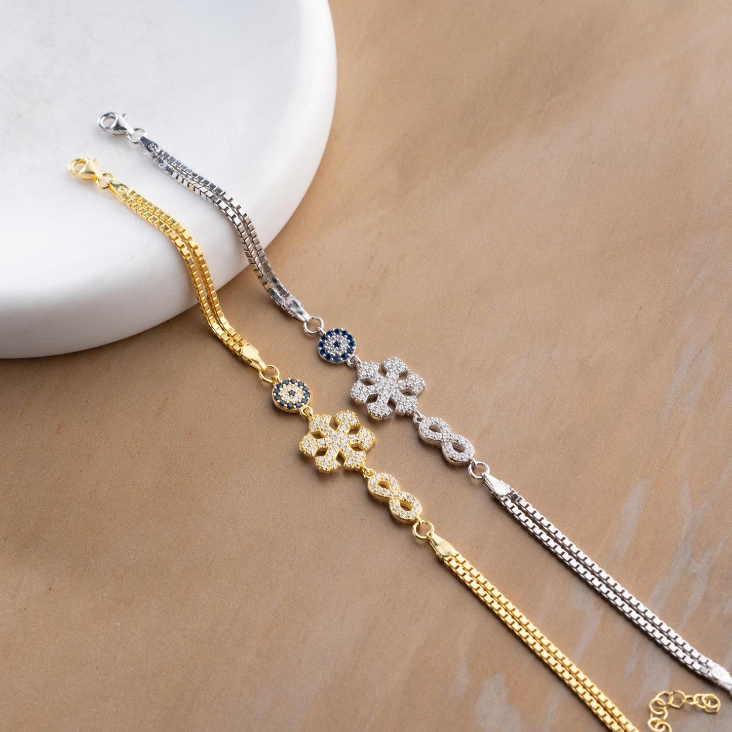 Double chain bracelet with snowflake, infinity, and evil eye charms, crafted in 925 Sterling Silver and 14K Gold Plated, perfect for Christmas or special occasions.