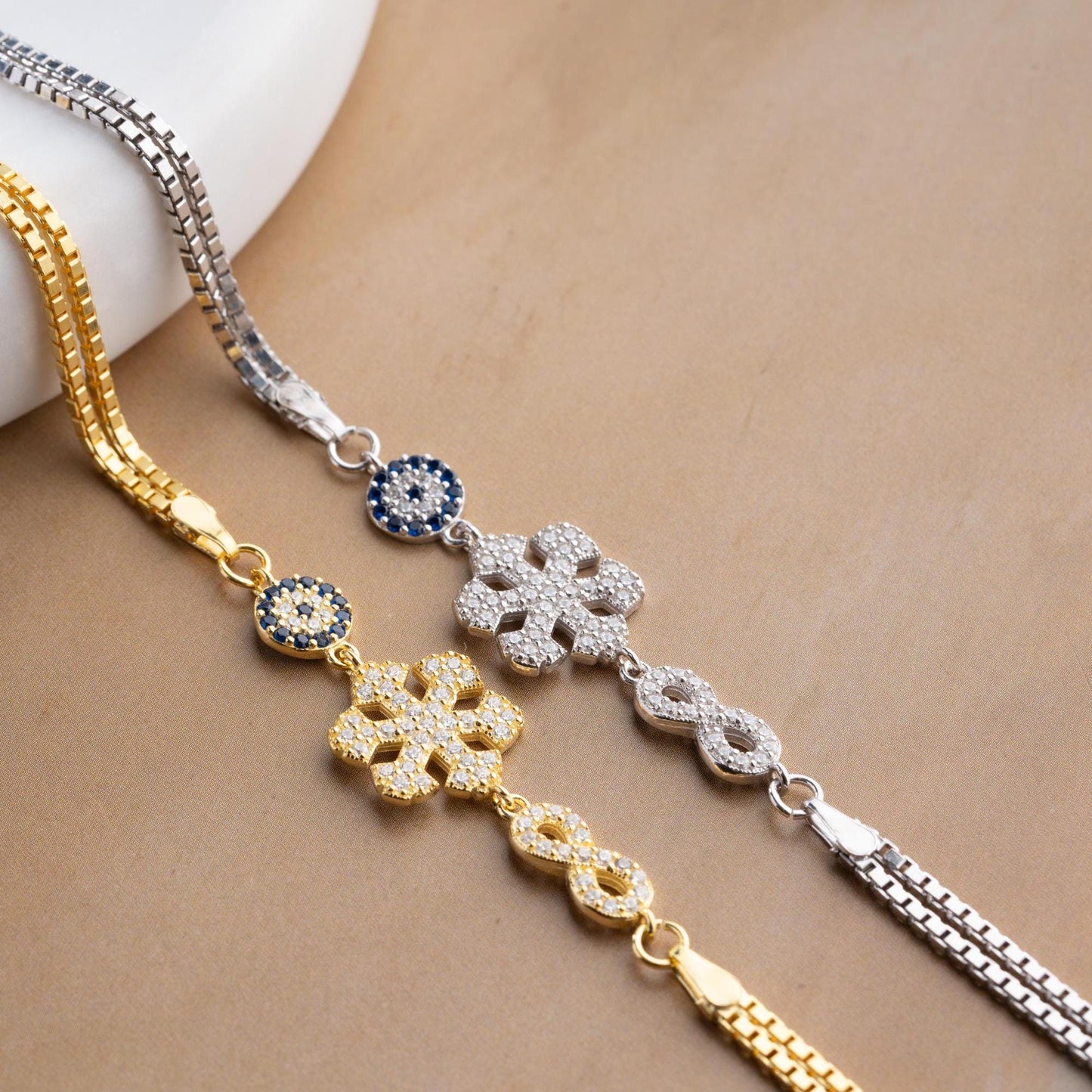 Double chain bracelet with snowflake, infinity, and evil eye charms, crafted in 925 Sterling Silver and 14K Gold Plated, perfect for Christmas or special occasions.