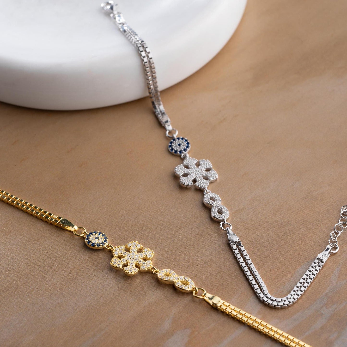 Double chain bracelet with snowflake, infinity, and evil eye charms, crafted in 925 Sterling Silver and 14K Gold Plated, perfect for Christmas or special occasions.