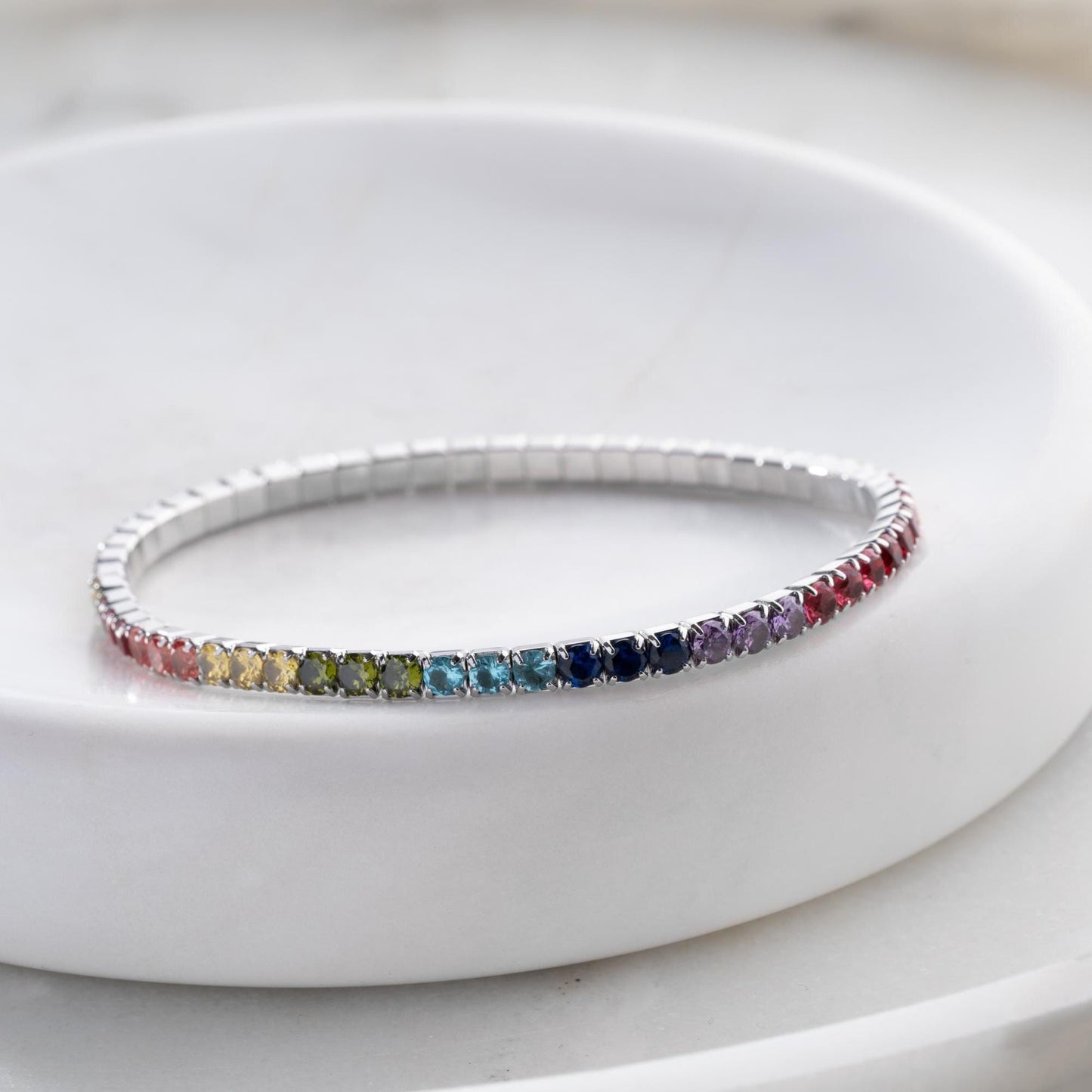Vibrant stackable tennis bracelet set featuring multicolored cubic zirconia stones, crafted in 925 Sterling Silver with a 14K Gold Plated option, perfect for festive and everyday wear.