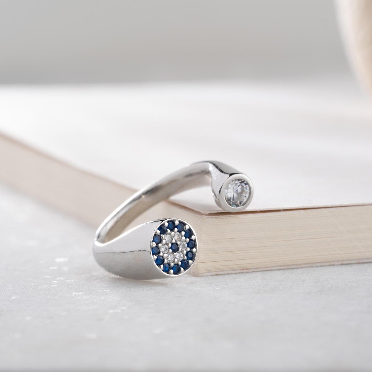 Adjustable open ring featuring a round evil eye charm with cubic zirconia stones, crafted in 925 Sterling Silver and 14K Gold Plated finish.