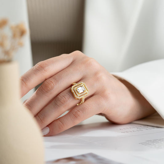 Elegant emerald cut double halo statement ring crafted in 925 sterling silver with cubic zirconia stones, available in silver and gold plated finishes.